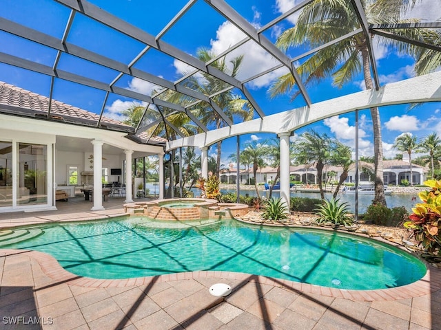 view of swimming pool with a lanai, a water view, an in ground hot tub, and a patio