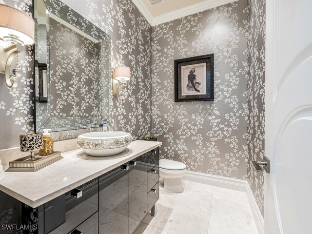 bathroom featuring vanity, toilet, and ornamental molding