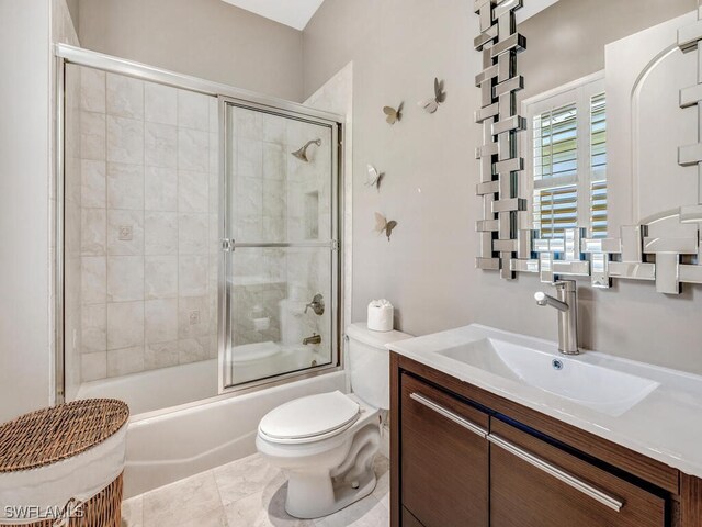 full bathroom featuring shower / bath combination with glass door, vanity, toilet, and tile patterned flooring