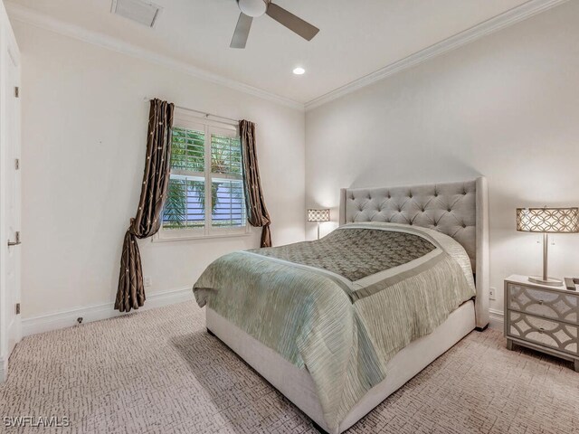 carpeted bedroom featuring ceiling fan and ornamental molding