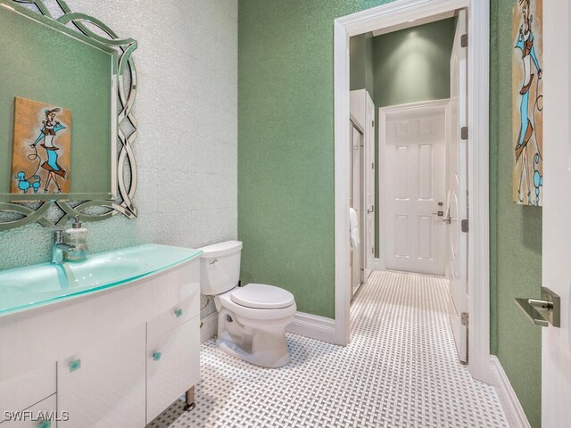 bathroom with tile patterned floors, vanity, and toilet