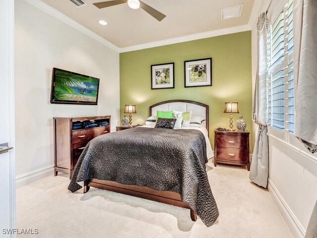 bedroom with light carpet, ceiling fan, and crown molding