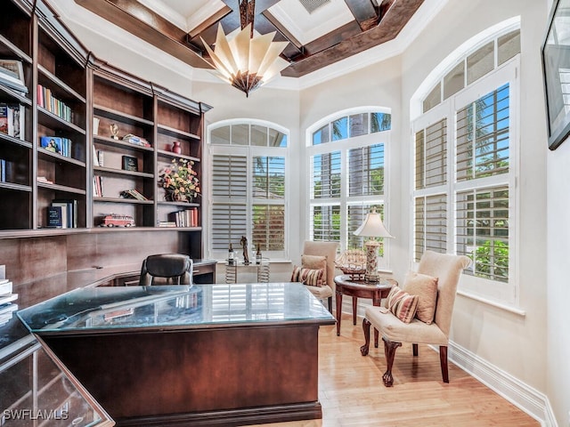 office featuring beam ceiling, a wealth of natural light, coffered ceiling, and light wood-type flooring