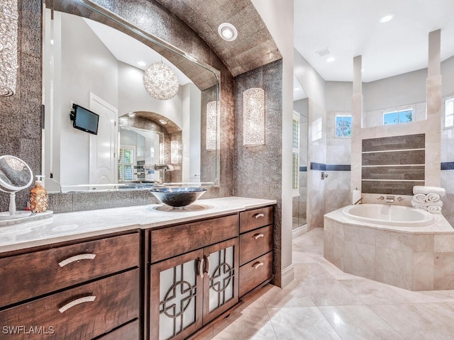 bathroom featuring vanity and plus walk in shower