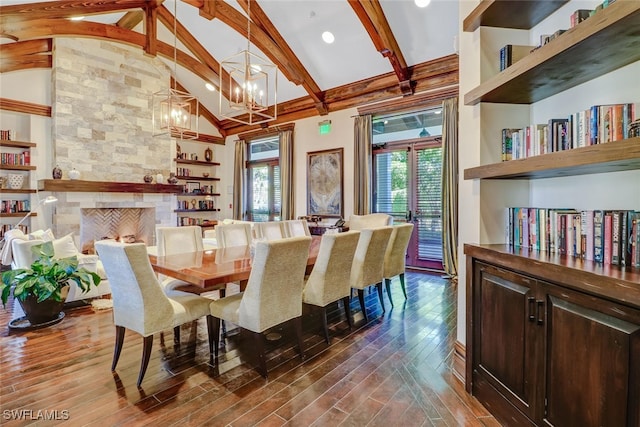 dining room featuring beam ceiling, an inviting chandelier, high vaulted ceiling, a fireplace, and hardwood / wood-style floors