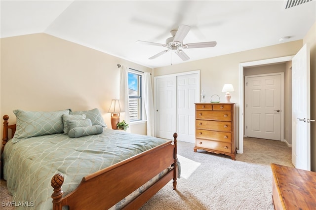 carpeted bedroom with a ceiling fan, a closet, visible vents, and vaulted ceiling