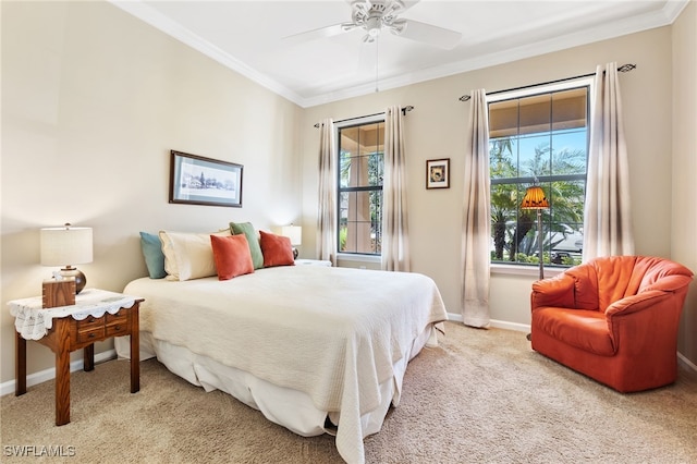 carpeted bedroom featuring crown molding and ceiling fan