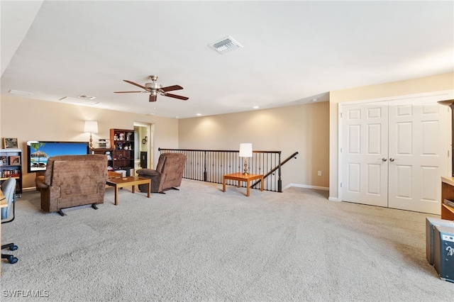 living room featuring carpet and ceiling fan