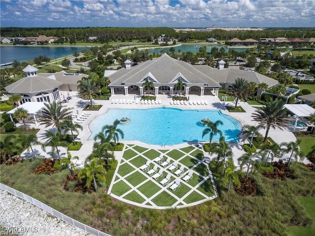 view of pool with a patio and a water view