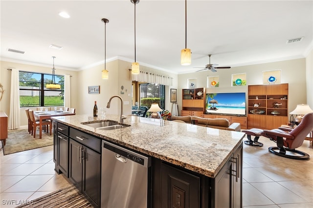 kitchen featuring a kitchen island with sink, dishwasher, light stone counters, sink, and ceiling fan