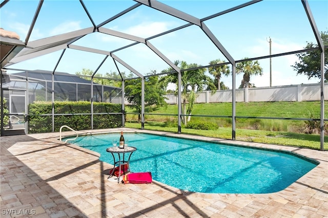 view of swimming pool featuring a yard, a patio, and glass enclosure