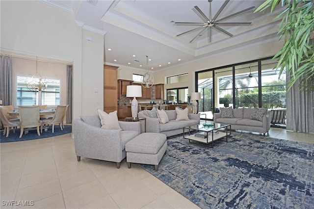 living room featuring crown molding, a towering ceiling, light tile patterned floors, and plenty of natural light