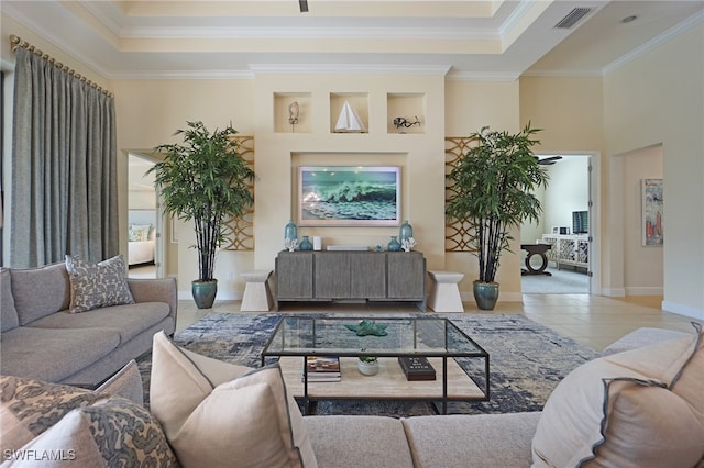 living room featuring light tile patterned flooring, crown molding, and a high ceiling