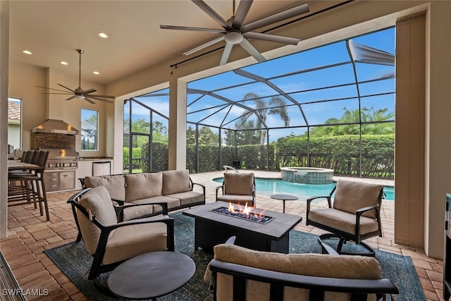 view of patio / terrace with ceiling fan, a grill, an outdoor living space, a lanai, and exterior kitchen