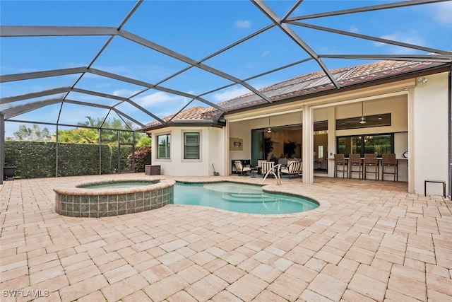 view of pool featuring glass enclosure, an in ground hot tub, ceiling fan, central AC, and a patio area