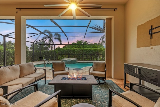 patio terrace at dusk featuring a fenced in pool, an outdoor living space with a fire pit, and a lanai