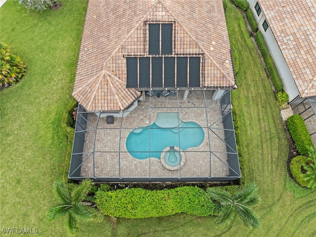 view of swimming pool with a lanai, a patio, and a yard