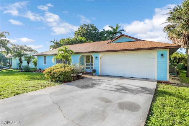 ranch-style home with a front lawn, a garage, and central AC