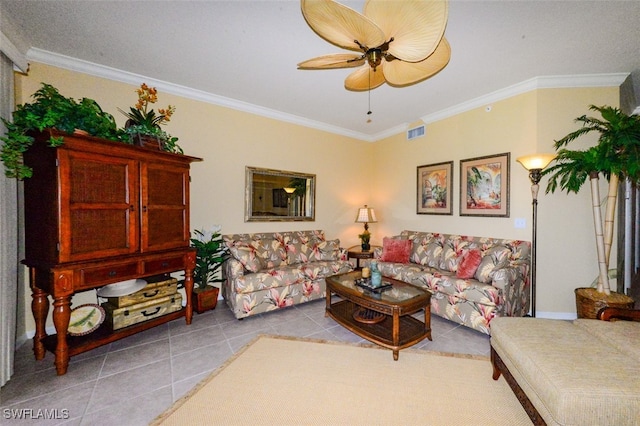 living room featuring ceiling fan, crown molding, and light tile patterned floors