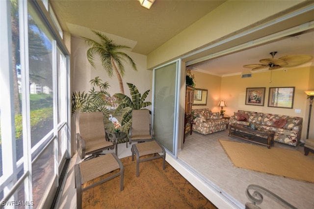 sunroom featuring ceiling fan