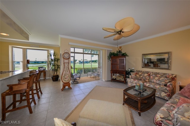 tiled living room featuring ceiling fan and ornamental molding