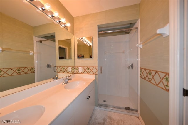 bathroom with a shower with door and vanity