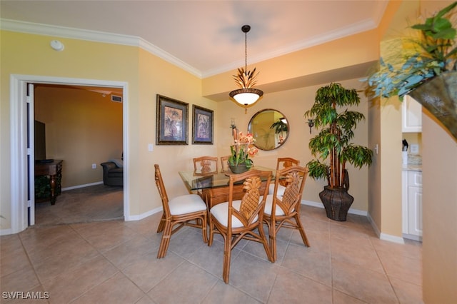 tiled dining area featuring ornamental molding