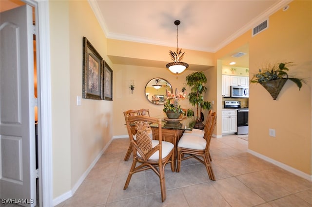 dining space with ornamental molding and light tile patterned floors