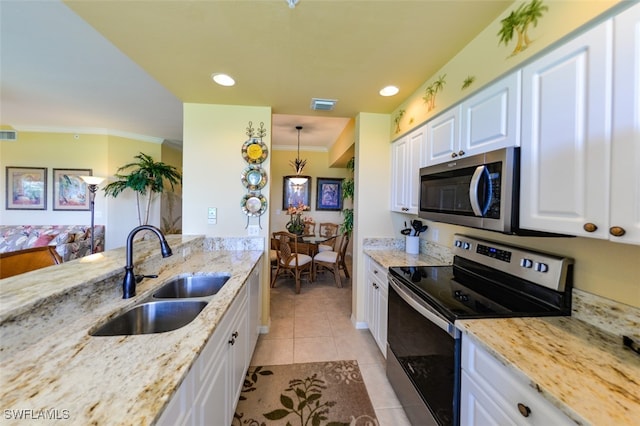 kitchen featuring stainless steel appliances, sink, white cabinetry, light tile patterned flooring, and light stone countertops