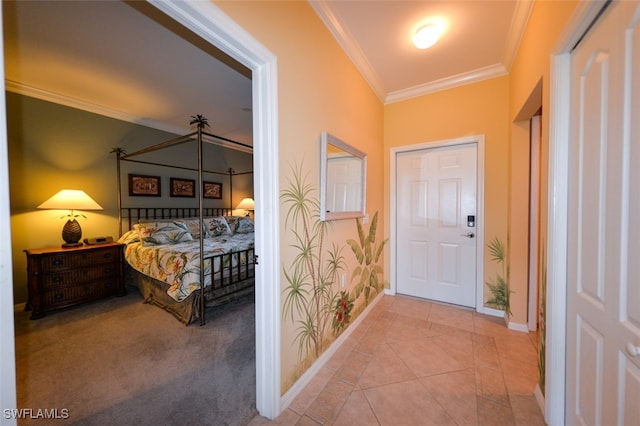 bedroom with ornamental molding, light tile patterned floors, and a closet