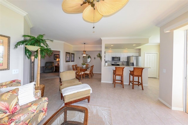 tiled living room featuring ornamental molding, sink, and ceiling fan