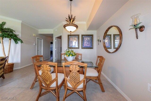 tiled dining space featuring crown molding