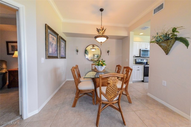 dining room featuring crown molding and light tile patterned flooring