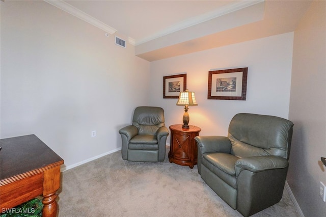 sitting room featuring ornamental molding and light colored carpet