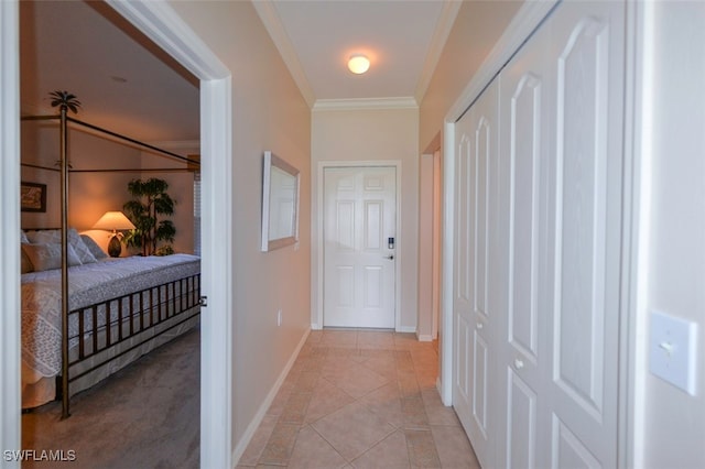 corridor featuring crown molding and light tile patterned floors