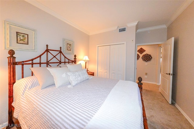 bedroom featuring crown molding, light colored carpet, and a closet