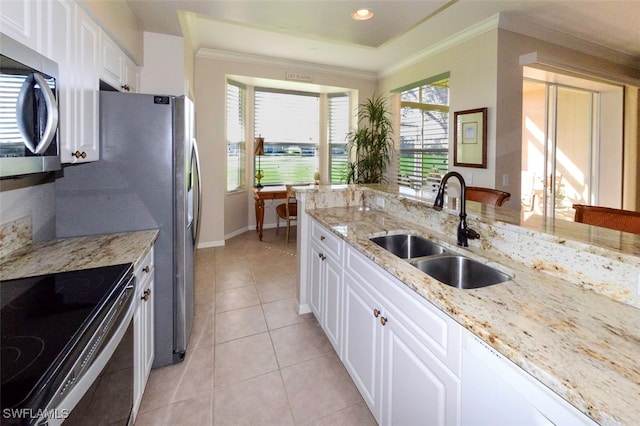 kitchen with white cabinetry, sink, light stone countertops, and appliances with stainless steel finishes