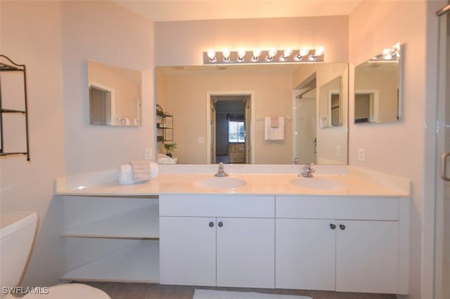 bathroom featuring vanity, toilet, and an enclosed shower