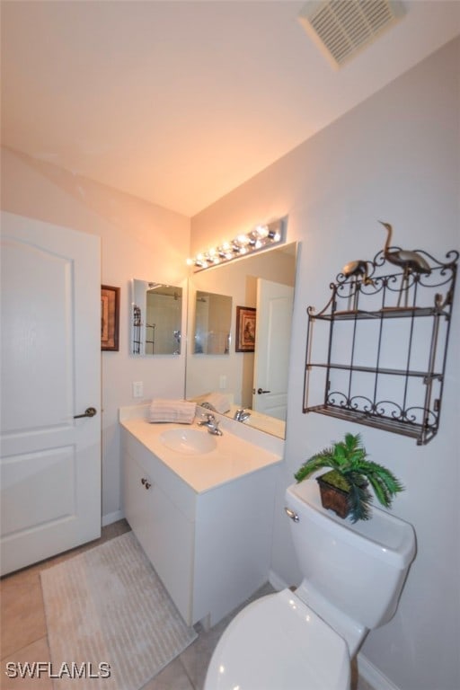 bathroom with vanity, tile patterned floors, and toilet