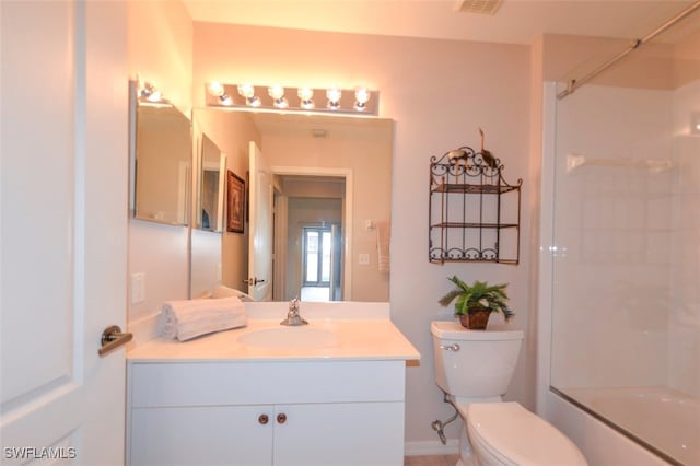 full bathroom with vanity, bath / shower combo with glass door, and toilet