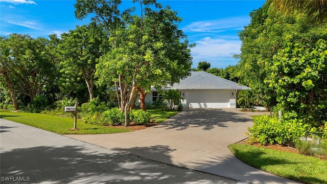 view of front of house with a front yard and a garage