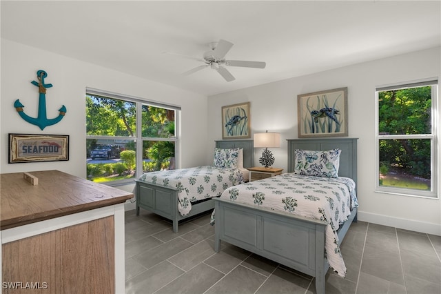 tiled bedroom featuring ceiling fan