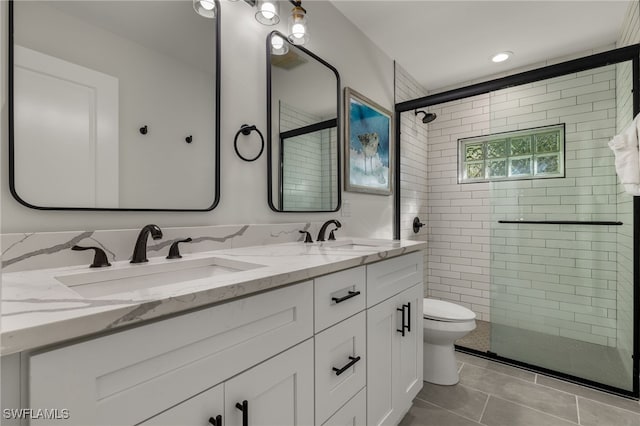 bathroom featuring vanity, toilet, tile patterned floors, and a shower with shower door