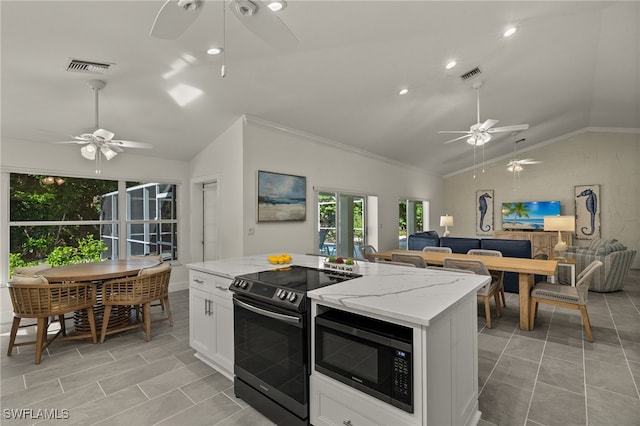 kitchen featuring electric stove, light stone counters, ceiling fan, vaulted ceiling, and black microwave