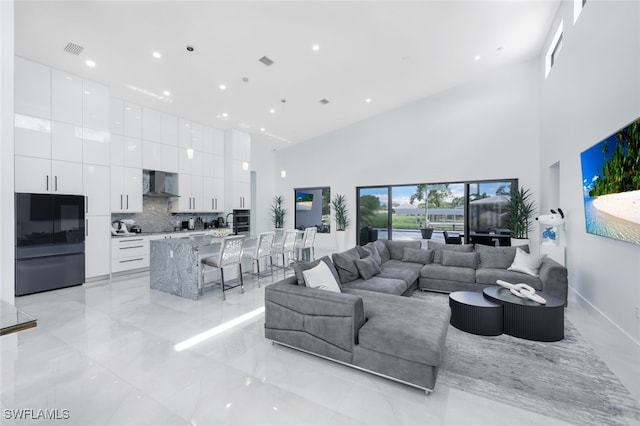 living room featuring a towering ceiling