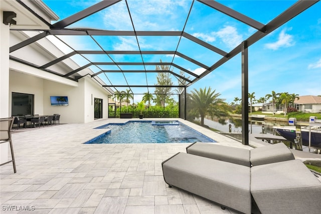 view of swimming pool featuring glass enclosure and a patio area