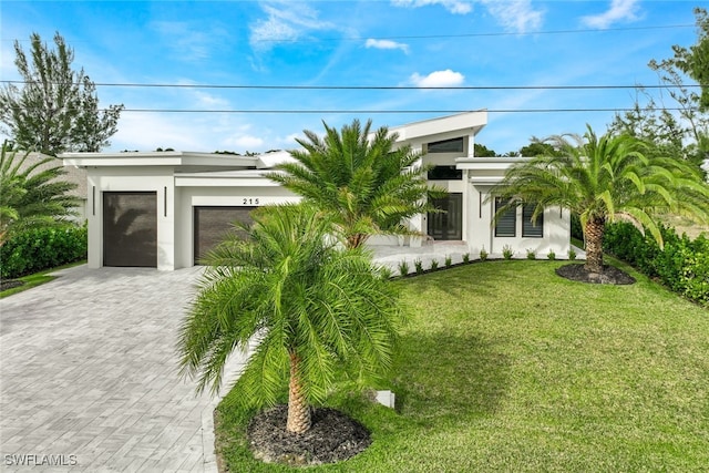 view of front of property with a garage and a front yard