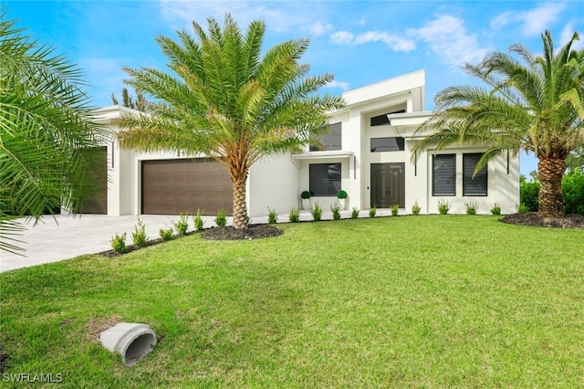 modern home featuring a garage and a front lawn