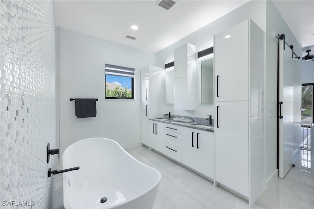 bathroom featuring vanity and a bath