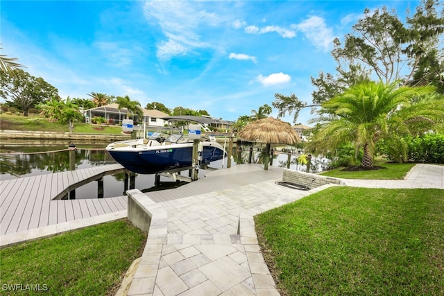 dock area featuring a lanai, a lawn, and a water view